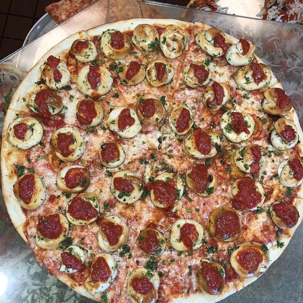 Valentino’s Pizzeria's large cheese pizza topped with garlic knots and marinara sauce.