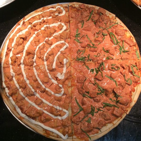 Valentino’s Pizzeria offers a half-and-half pizza with chicken and creamy sauce, one side with ranch, the other with basil.